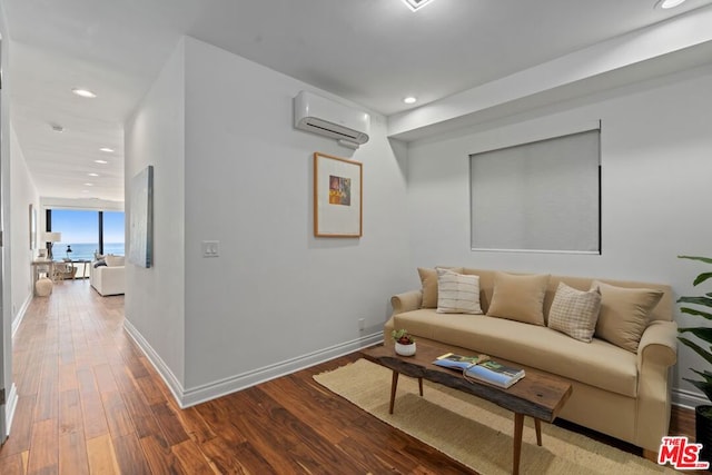 living room with hardwood / wood-style flooring and an AC wall unit