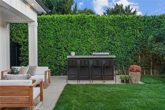 view of yard with an outdoor hangout area, a bar, and a patio