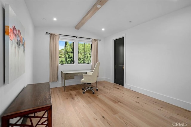 office area with light hardwood / wood-style flooring, lofted ceiling with beams, and built in desk