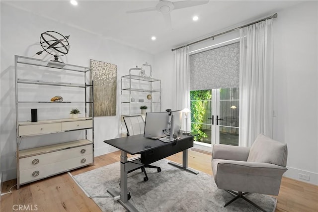 office space with ceiling fan and light hardwood / wood-style floors