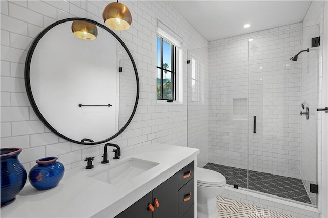 bathroom with vanity, backsplash, tile walls, toilet, and walk in shower