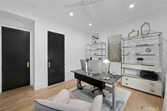 home office featuring ceiling fan and light hardwood / wood-style flooring