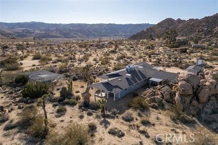 birds eye view of property featuring a mountain view