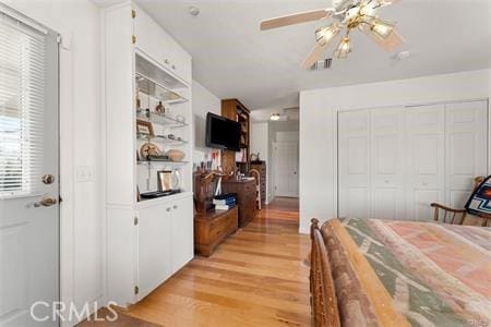 bedroom with ceiling fan and light hardwood / wood-style flooring