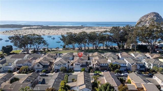 drone / aerial view with a beach view, a water view, and a residential view