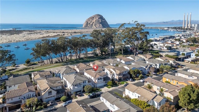 drone / aerial view featuring a water view and a residential view