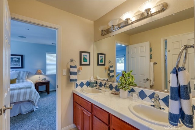 bathroom featuring a sink, double vanity, and connected bathroom