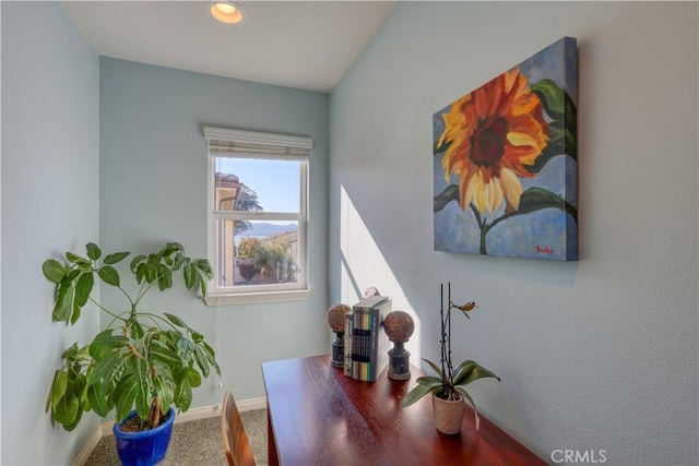 office space featuring carpet floors and baseboards