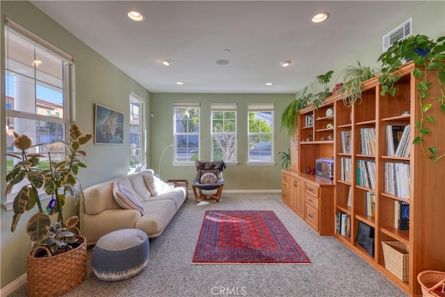 sitting room with light colored carpet, visible vents, baseboards, and recessed lighting