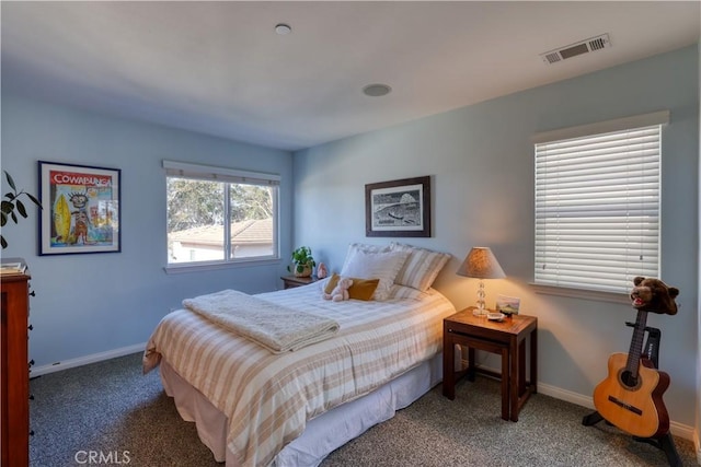 carpeted bedroom featuring visible vents and baseboards