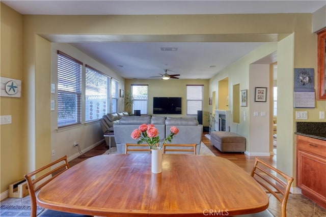 dining area with ceiling fan, visible vents, and baseboards