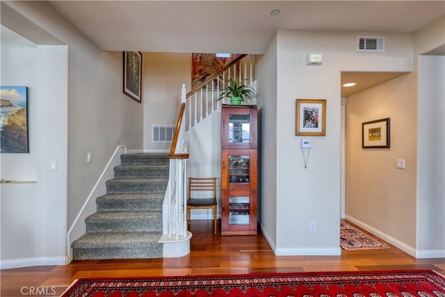 staircase with wood-type flooring