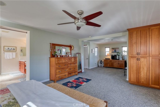 bedroom with visible vents, baseboards, and light colored carpet