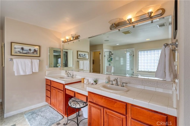 bathroom with vanity, tile patterned flooring, and a shower with door