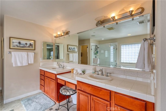 full bath featuring double vanity, a sink, visible vents, and a shower stall