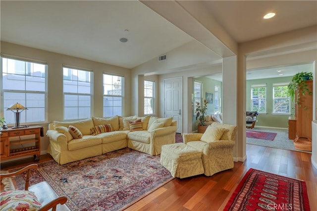 sunroom featuring visible vents and vaulted ceiling