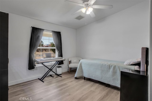 bedroom with ceiling fan and light hardwood / wood-style floors