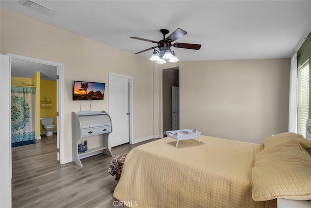 bedroom with ceiling fan, hardwood / wood-style floors, and ensuite bath