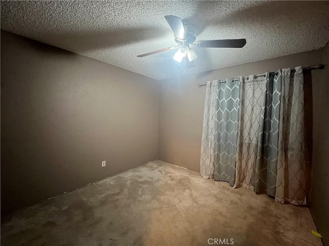 carpeted spare room with ceiling fan and a textured ceiling