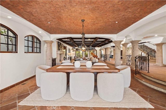 dining room with brick ceiling and decorative columns