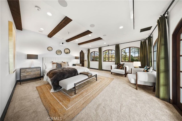 carpeted bedroom with beamed ceiling