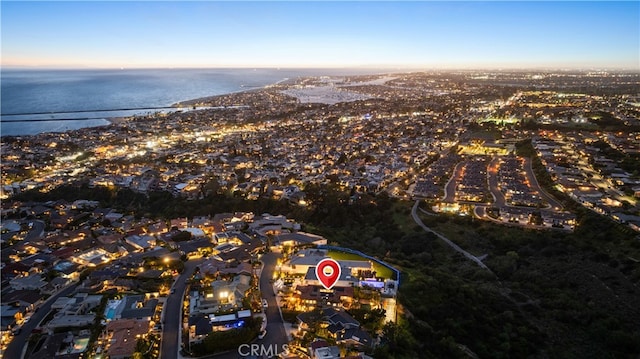 aerial view at dusk with a water view