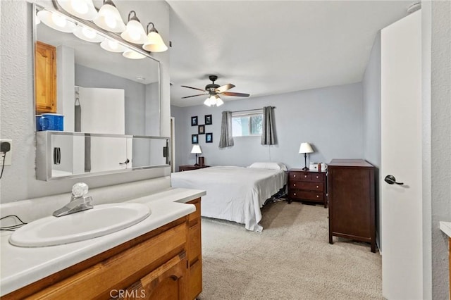 bedroom with ceiling fan, light colored carpet, and sink