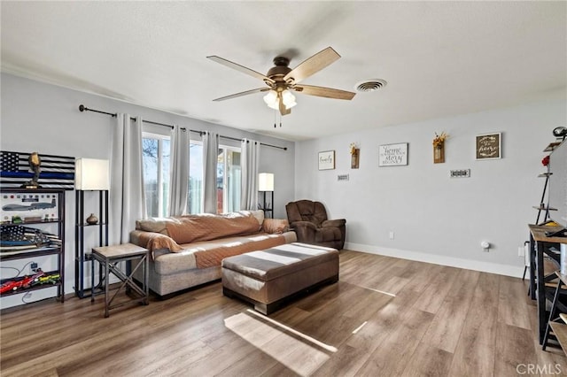 living room with ceiling fan and wood-type flooring