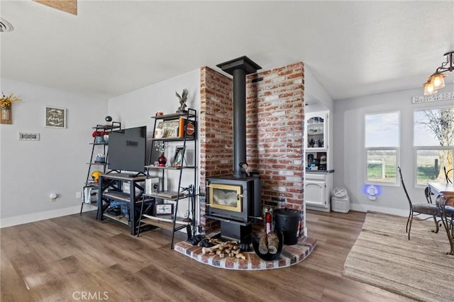 living room featuring hardwood / wood-style flooring and a wood stove