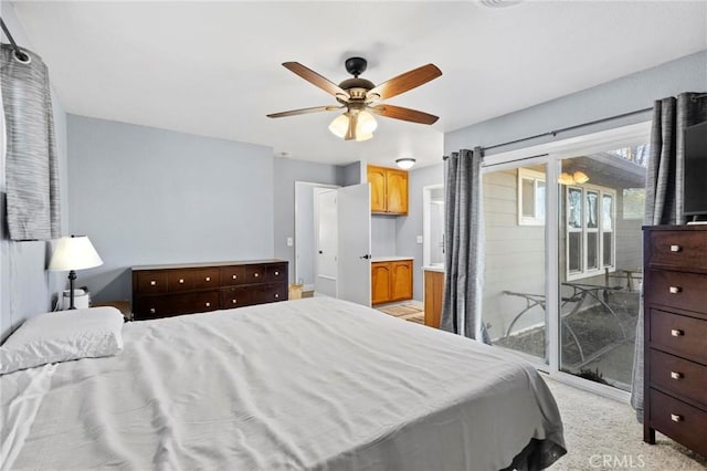 bedroom featuring access to outside, light carpet, and ceiling fan