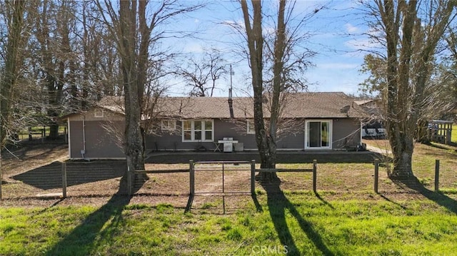 rear view of property with a lawn