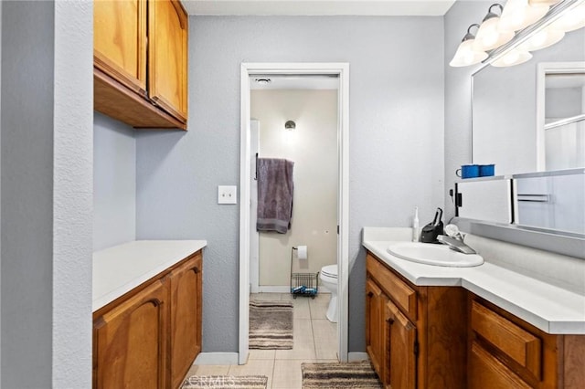 bathroom with vanity, tile patterned floors, a chandelier, and toilet