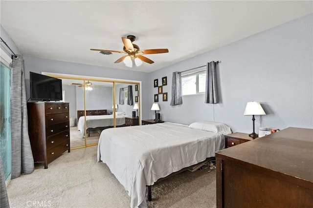 carpeted bedroom with a closet and ceiling fan