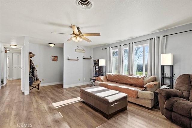 living room featuring light hardwood / wood-style floors and ceiling fan