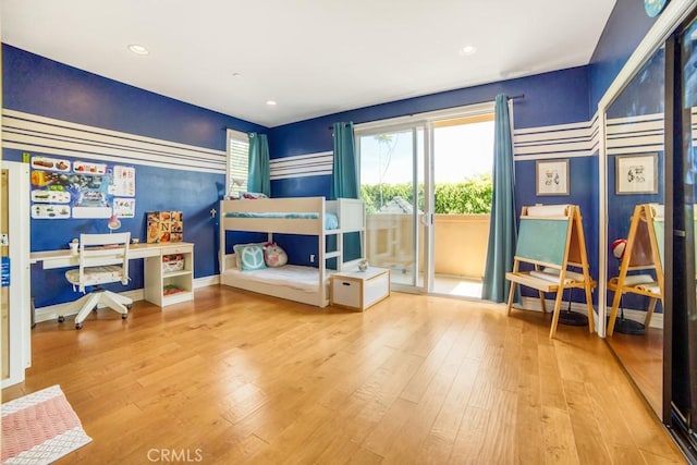 bedroom with baseboards, recessed lighting, wood finished floors, and access to exterior