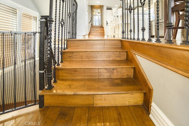 staircase with wood finished floors