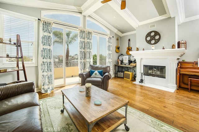 sunroom featuring a fireplace with flush hearth, visible vents, vaulted ceiling with beams, and ceiling fan