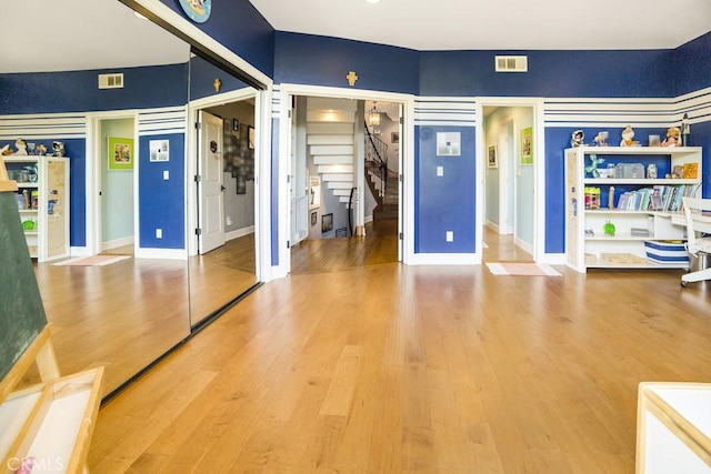 unfurnished bedroom with wood finished floors, visible vents, and baseboards