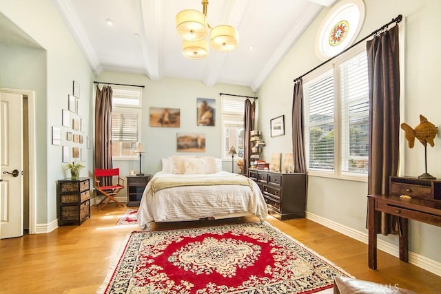 bedroom with light wood-type flooring, beam ceiling, and multiple windows