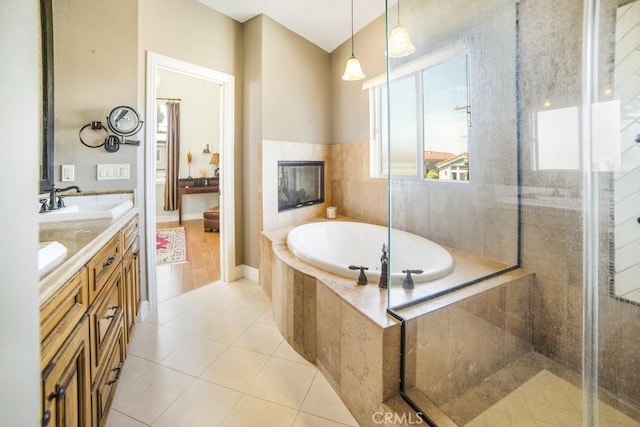 bathroom with double vanity, a bath, tile patterned floors, a tile shower, and a sink