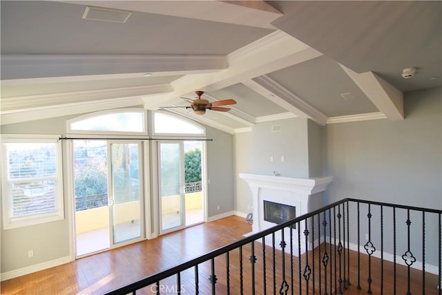 corridor featuring vaulted ceiling with beams, crown molding, wood finished floors, and baseboards