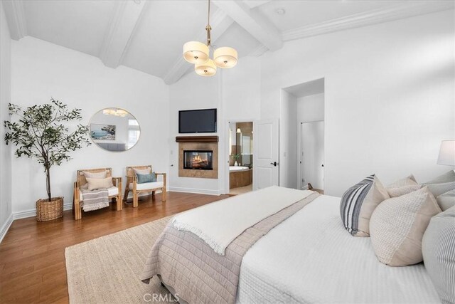 1612 Speyer Ln, Redondo Beach, CA 90278 - bedroom with wood finished floors, beamed ceiling, a glass covered fireplace, high vaulted ceiling, and ensuite bath