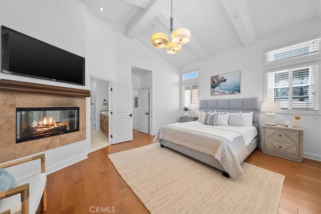 1612 Speyer Ln, Redondo Beach, CA 90278 - bedroom featuring beam ceiling, a chandelier, wood finished floors, a tile fireplace, and high vaulted ceiling