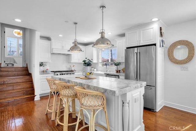 1612 Speyer Ln, Redondo Beach, CA 90278 - kitchen featuring stainless steel appliances, dark wood-style floors, a center island, white cabinets, and recessed lighting