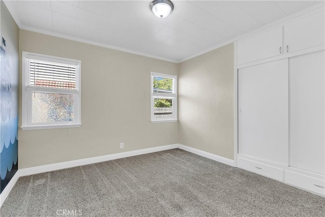 unfurnished bedroom featuring carpet floors, a closet, and ornamental molding