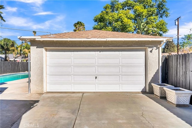 garage featuring a fenced in pool