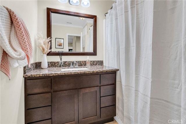 bathroom with crown molding and vanity