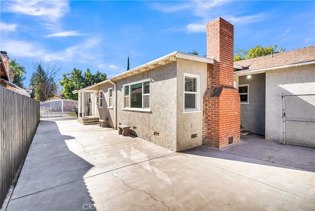 view of side of home featuring a patio