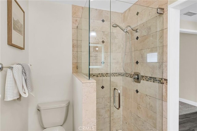 bathroom featuring toilet and walk in shower