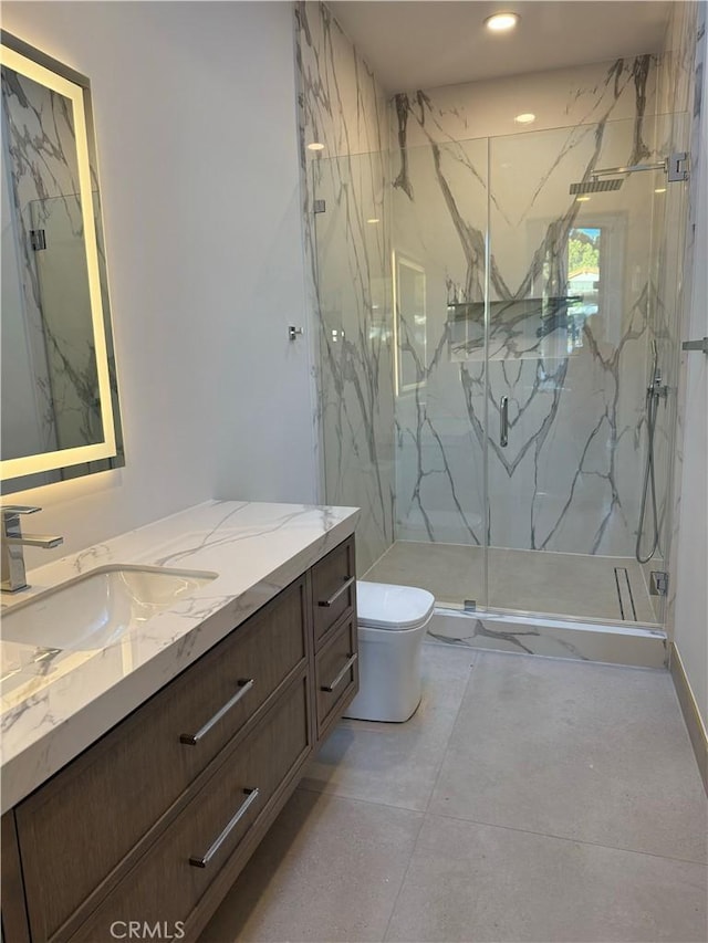 bathroom featuring a shower with shower door, toilet, and vanity